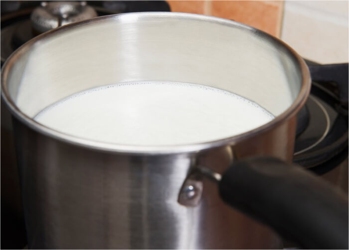 Для этого рецепта йогурта необходимо подогреть (но не кипятить!) молоко до 75-80 градусов, затем остудить его до 35-40 градусов. Проверять температуру лучше всего кухонным термометром, чтобы на выходе гарантированно получить вкусный, густой и полезный йогурт. В качестве посуды следует использовать эмалированную кастрюлю, из которой потом молоко переливается в стеклянную или керамическую посуду.